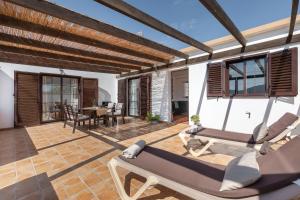 a patio with two lounge chairs and a table at Casa Tagaide in Tuineje
