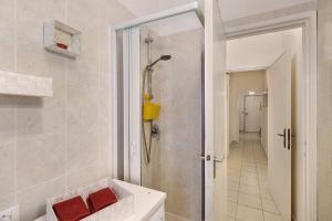 a bathroom with a walk in shower and a sink at Casa Rosso Melograno in Alassio