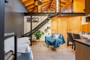 a loft conversion with a staircase and a living room at Chalet Helnes - chalet contemporain in Saint-Oyen