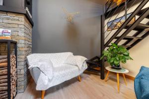 a living room with a chair and a staircase at Chalet Helnes - chalet contemporain in Saint-Oyen