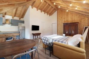a room with a bed and a table and a kitchen at Ca' Vittorio in Rossiglione