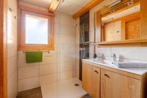 a bathroom with a sink and a shower at Chalet Helnes - chalet contemporain in Saint-Oyen +20 photos