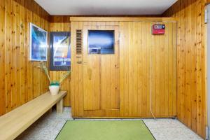 a wooden room with a bench and a door at Haus vor Anker in Feldberg