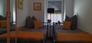 a room with two beds and a table with pillows at Ferienwohnung am Huthainberg in Börnichen