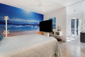 a bedroom with a large bed and a television at Pardelo in Los Menores