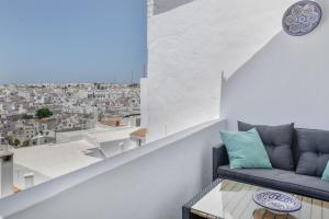 a living room with a couch and a view of a city at Casa Castillo con Jardín in Vejer de la Frontera