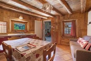 a kitchen and dining room with a table and a couch at Maison Peroulaz Charvensod in Charvensod