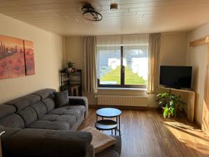 a living room with a couch and a flat screen tv at Ferienwohnung Strey in Rosenow