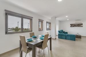 a dining room and living room with a table and chairs at Edificio Bentejui 2 in Las Palmas de Gran Canaria +17 photos