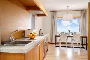 a kitchen with a sink and a table with chairs at Welling in Punta Mujeres +18 photos