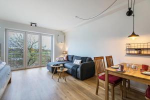 a living room with a blue couch and a table at Husbyries Wohnung 11 in Husby