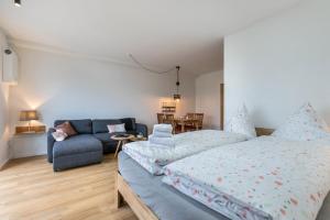 a bedroom with a bed and a couch at Husbyries Wohnung 11 in Husby +7 photos