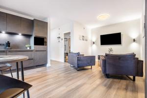 a kitchen and living room with a table and chairs at Egge Resort 7g mit Whirpool u Sauna in Altenbeken