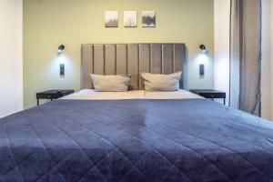 a bedroom with a large bed with two night stands at Egge Resort 7g mit Whirpool u Sauna in Altenbeken