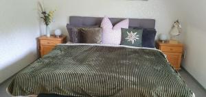 a bedroom with a large bed with purple pillows at Fewo D und R Schwesternherz in Naumburg