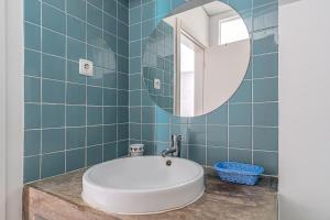 a bathroom with a sink and a mirror at Calçada in Alcácer do Sal +30 photos