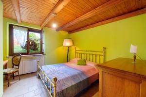 a bedroom with a bed and a desk and a window at Il Trucchetto - Castagneto Po in Chivasso