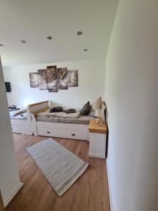 a white living room with a couch and a table at Waldstein Terrassen in Weißenstadt