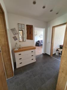 a room with a dresser and a living room at Waldstein Terrassen in Weißenstadt +24 photos