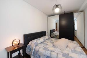a bedroom with a bed and a mirror at Romantica e Accogliente Mansardina in Savona