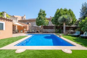 a swimming pool in the yard of a house at Ca'n Blanch in Biniamar