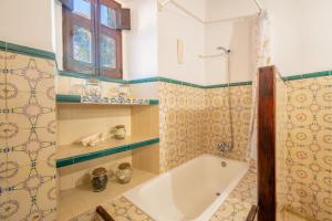 a bathroom with a bath tub and a window at Ca'n Blanch in Biniamar +21 photos