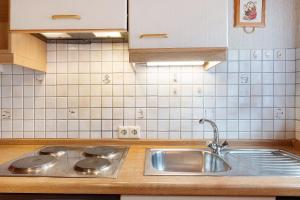 a kitchen with a sink and a counter top at Ferienwohnungen Vogt's Libding in Bad Rippoldsau-Schapbach +57 photos