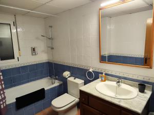 a bathroom with a toilet and a sink and a mirror at Marina Golf in Mojácar +28 photos