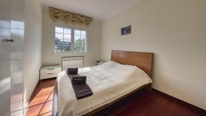a bedroom with a bed and a window at Costacabana - Villa Beyonce in Lloret de Mar +8 photos