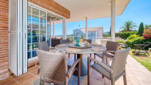 a dining room with a table and chairs on a patio at Costacabana - Villa Beyonce in Lloret de Mar
