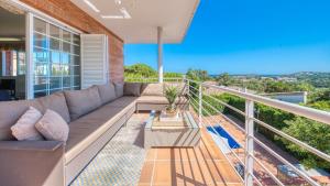 a living room with a couch on a balcony at Costacabana - Villa Beyonce in Lloret de Mar