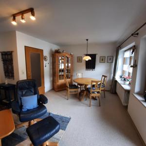a kitchen and dining room with a table and chairs at Ferienwohnung Hörnleblick in Burgberg