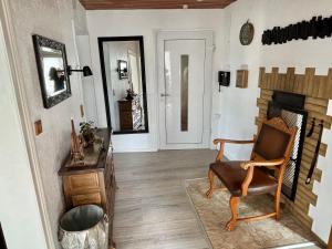 a living room with a chair and a fireplace at Sterntaler Melsungen in Melsungen