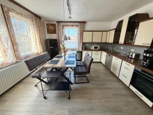 a kitchen with a table and chairs in it at Sterntaler Melsungen in Melsungen