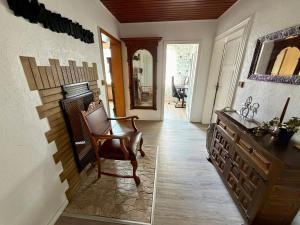 a living room with a chair and a mirror at Sterntaler Melsungen in Melsungen +18 photos
