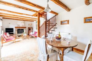 a dining room with a table and chairs and a fireplace at Ville Daniel in Pordic +16 photos