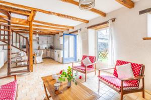 a living room with red chairs and a table at Ville Daniel in Pordic