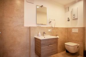 a bathroom with a sink and a toilet at Ferienwohnung Legau in Legau +9 photos