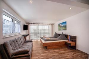 a living room with a couch and a table at Ferienwohnung Legau in Legau