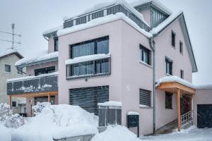 a house in the snow with snow at Ferienwohnung Legau in Legau