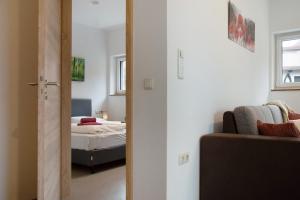 a bedroom with a bed and a door leading into a room at Mohnblume in Unterwittighausen