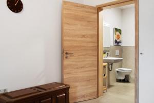 a bathroom with a wooden door and a sink at Mohnblume in Unterwittighausen +17 photos