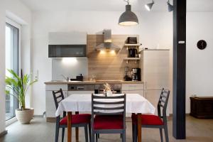 a kitchen with a white table and chairs and a kitchen with a kitchen at Mohnblume in Unterwittighausen