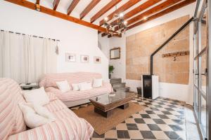 a living room with two couches and a fireplace at La Sastreria in Pollença