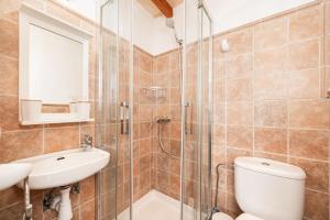 a bathroom with a shower and a toilet and a sink at La Sastreria in Pollença +16 photos