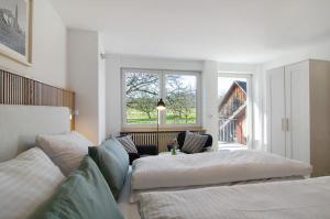 a bedroom with two beds and a window at Gästehaus Schwert in Salem