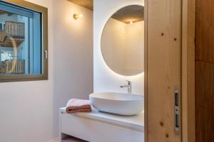 a bathroom with a sink and a mirror at Lena Dolomites Suite in Villnoss +24 photos