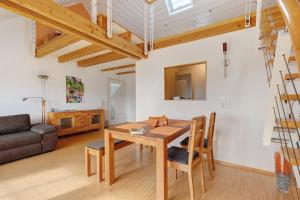 a living room with a wooden table and a couch at Birkethof Romantik-Appartement in Mickhausen