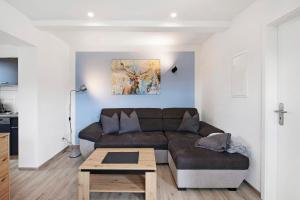 a living room with a couch and a table at Ferienwohnung Pfauenhof in Harztor