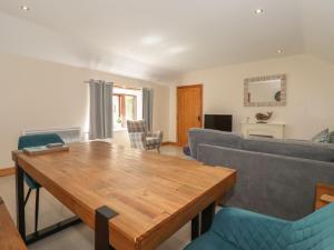 a living room with a wooden table and chairs at Daisy Nook in Hull